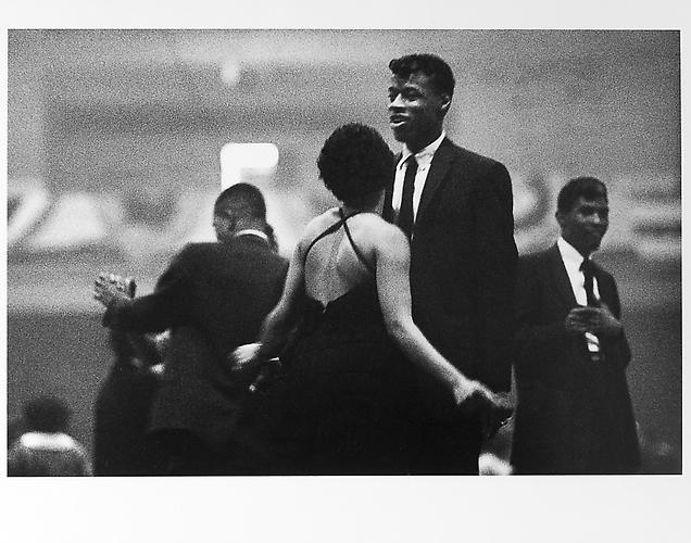 Harlem dance, woman in dress with crossed straps 
mid 1950s
Gelatin Silver Print