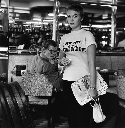 Jean Seberg walking out of a cafe on the Champs Elysees to join the team shooting (A Bout De Souffle)
1959 
gelatin silver print