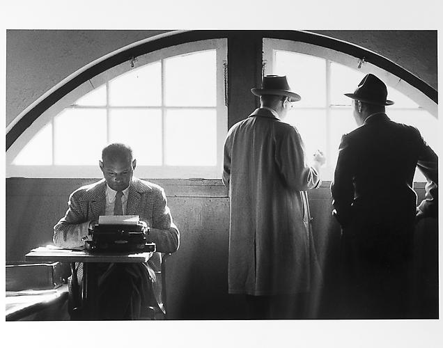 Sprits writers, one at typewriter 
mid 1950s
Gelatin Silver Print