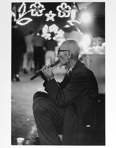 Old man with flute at San Gennarro Festival 
mid 1950s
Gelatin Silver Print