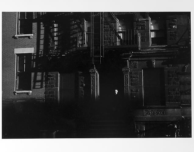 Facade of building, small white face in shadows 
mid 1950s
Gelatin Silver Print