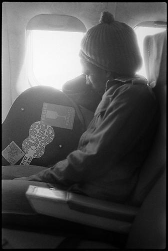 Kate Simon, Bob sleeping on the plane, leaning on guitar case