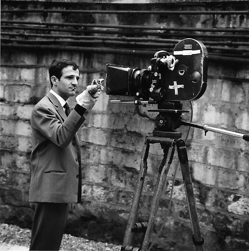 Francois Truffaut, cigarette in his mouth, standing in front of an Éclair CAMEFLEX CM3 camera holding a hand puppet in front of the lens
1961
gelatin silver print