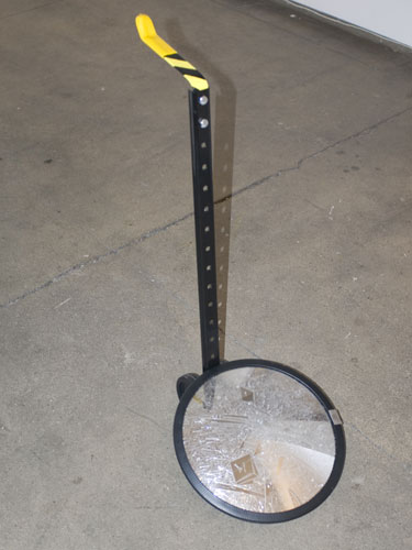 Marco Maggi, 2010, To Walk (Dog Mirror) , Cuts on mirror, metal, hardware,
27 x 12.5 inches diameter  (mirror)