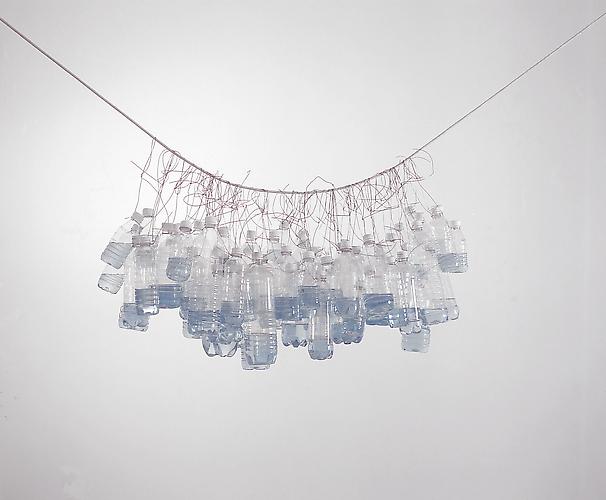 Tony Feher
It Seemed a Beautiful Day 2002 
bottle cluster approximately 48 x 23 x 23 inches 
clear plastic beverage bottles with white screw caps, galvanized steel wire