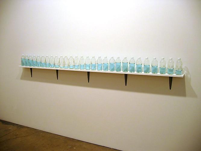Tony Feher
Just So 2002 
overall: 7 1/4 x 100 inches 
28 clear glass bottles with white plastic screw caps, distilled water, food coloring