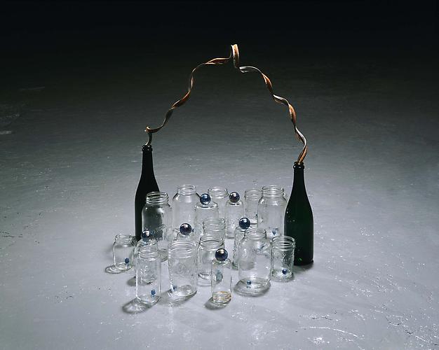 Tony Feher
(Flourish) 2007 
24 3/4 x 31 x 23 inches
glass bottles, glass jars, glass marbles, metal ribbon