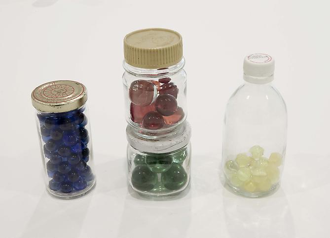 Tony Feher
Untitled circa 1992 
overall dimensions: 7 x 9 1/2 x 2 1/4 inches 
17.8 x 24.1 x 5.7 cm 
glass jars with metal screw lids, red, green, blue and yellow marbles