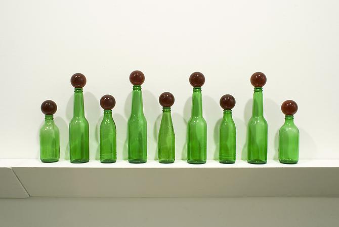Tony Feher
Untitled, 2011
9 green glass bottles and 9 red glass marbles
11 x 36 x 3 1/2 inches