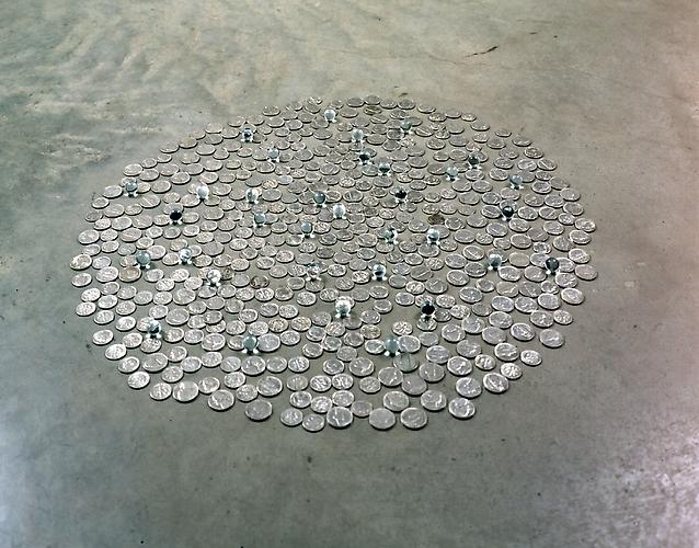 Tony Feher
D.C.FIVEANDIME 1999 
approximately 23 inches in diameter 
nickels, dimes, and 35 clear marbles