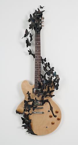 Paul Villinski, Rise
 (2011)
Electric Guitar, Aluminum (found Cans), Wire, Soot
44h x 15.5w x 9d in (111.76h x 39.37w x 22.86d cm)