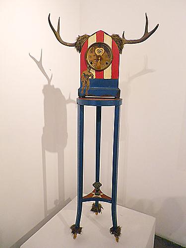 Shrine of the Great American Weiner, 1962-63  
Assemblage with table, clock case, antlers, baby pacifier, fur and oil 
51 x 22 x 9 inches