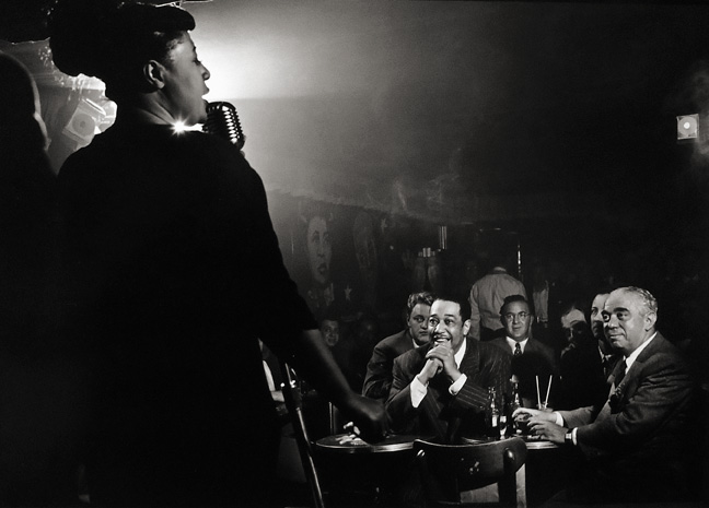 Herman Leonard, Ella Fitzgerald, Stan Hasselgard, Duke Ellington, Benny Goodman and Jack Robbins, Downbeat Club, New York City
1949