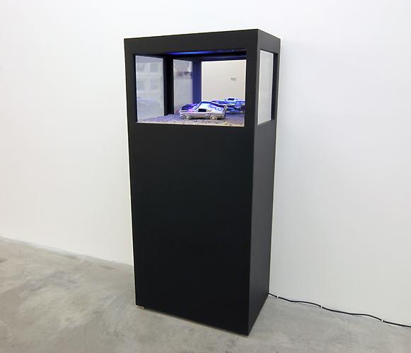 Phoenix, 2011
(unique)
television, car, video (5 minute seamless loop), sand and wood
20 x 28 x 67 inches