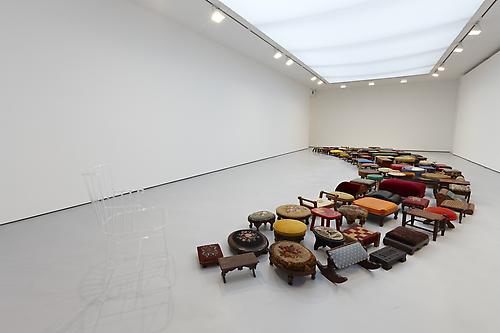 <i>Un-rest</i>, 2010
128 foot stools and 1 glass chair
Installation dimensions: 2 ft 10 in x 39 ft 4 in x 14 ft 6 in inches (86.4 x 1198.9 x 442 cm); Chair dimensions: 33 x 18 x 20 inches (83.8 x 45.7 x 50.8 cm)