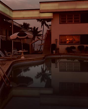 Joel Meyerowitz 
Pool, Dusk, Sun in Window, Florida, 1978