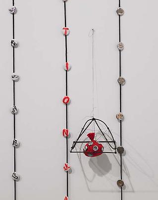 <i>Red pouch with pin badges in cage (Ballot badge rouge en cate)</i>, 2009 Image