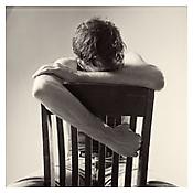 <i>David Wojnarowicz with Chair</i>
1983
Gelatin-silver print
Sheet: 13 5/8  x 10 7/8 inches; 35 x 28 cm