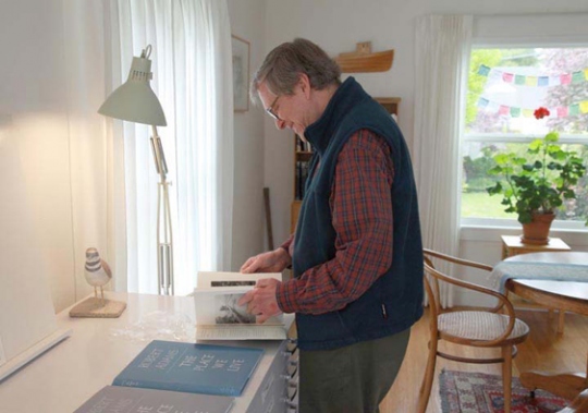 Robert Adams looking through the first bound copy of his book, <i>What Can We Believe Where?</I> Via <a href="http://yalepress.wordpress.com/2012/01/06/joshua-chang-on-robert-adams-bibliography-of-photography/">Joshua Chuang and the Yale Press Log<http://yalepress.wordpress.com/2012/01/06/joshua-chang-on-robert-adams-bibliography-of-photography/></a>.