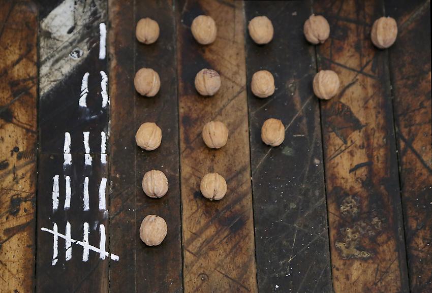 Mel Bochner<br />5 ≠ 5<br />1972<br />walnuts and chalk on floor<br />size determined by installation<br />