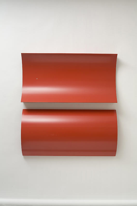 Charlotte Posenenske<br />Relief, Series B, 1967<br />RAL red spray paint on sheet aluminum, concavely and convexly arched<br />39 3/8 x 19 5/8 x 5 1/2 inches<br />