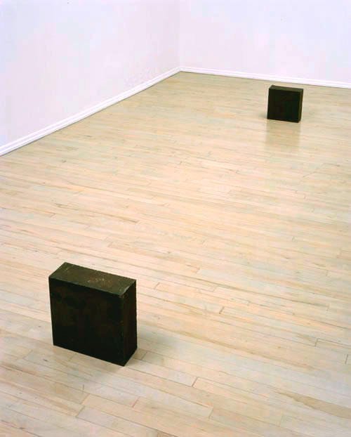 RICHARD SERRA<br />Unequal Elevations<br />1973<br />hot-rolled steel, in two parts<br />first block: 11 x 11 x 5 inches <br />  (27.9 x 27.9 x 12.7 cm); <br />second block: 12 1/16 x 12 1/16 x 5 1/4 inches<br />  (30.5 x 30.5 x 13.3 cm)<br />