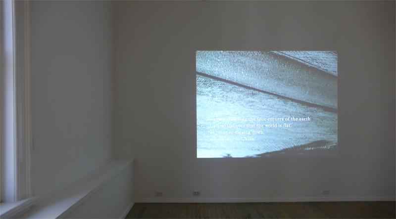 FIONA TAN<br />Downside Up<br />2002<br />Betacam saftey master, table-top projector, dvd player, amplifier, speakers, pedistal<br />