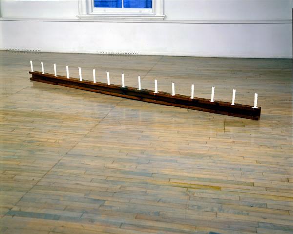 Richard Serra<br />Candle Piece<br />1967<br />wood and candles			<br />5 x 144 x 3 ½ inches (wood)<br />height with candles vary<br />