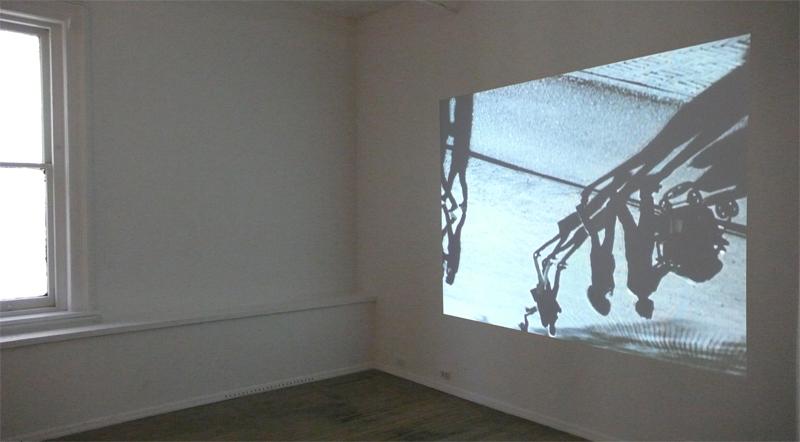 FIONA TAN<br />Downside Up<br />2002<br />Betacam saftey master, table-top projector, dvd player, amplifier, speakers, pedistal<br />
