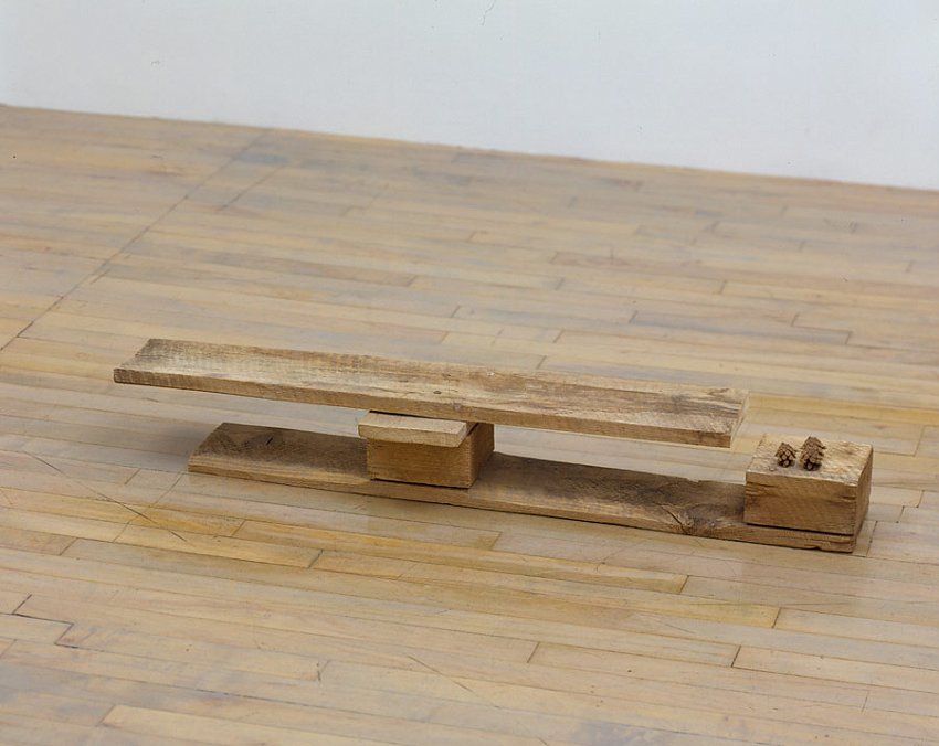 Helen Mirra<br />Sarton<br />	2006	<br />	pallet wood, pine cones<br />	6 1/16 x 41 x 8 inches<br />	 (15 x 104 x 20 cm)<br />