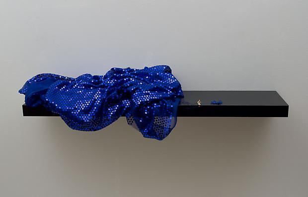 Forced Labor (Seamstress), 2012
Shelf with figurine and fabric, wall installation
10 x 43 x 10 1/4 inches Image